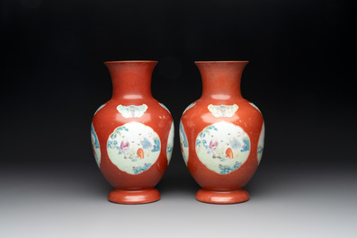 A pair of Chinese famille rose coral-red-ground vases with playing boys, 18/19th C.