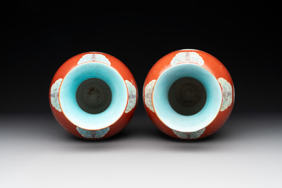 A pair of Chinese famille rose coral-red-ground vases with playing boys, 18/19th C.