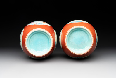 A pair of Chinese famille rose coral-red-ground vases with playing boys, 18/19th C.