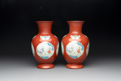 A pair of Chinese famille rose coral-red-ground vases with playing boys, 18/19th C.