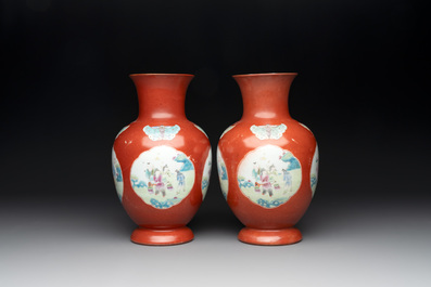 A pair of Chinese famille rose coral-red-ground vases with playing boys, 18/19th C.