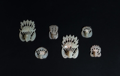 34 Chinese white and celadon jade phoenix-form hat ornaments, 19th C.