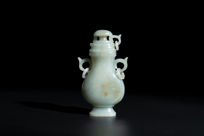 A Chinese white and russet jade lotus-form brush washer and two covered vases, Qing