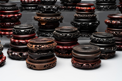 A large collection of 87 Chinese wooden stands, 19/20th C.