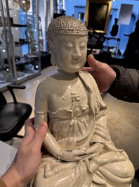 An extremely rare Chinese Swatow cream-glazed seated Buddha, Xuande mark, Ming