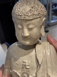 An extremely rare Chinese Swatow cream-glazed seated Buddha, Xuande mark, Ming
