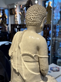 An extremely rare Chinese Swatow cream-glazed seated Buddha, Xuande mark, Ming