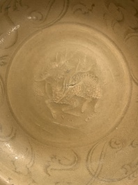 A Chinese Longquan celadon plate and two saucer dishes, Ming