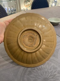 A Chinese Longquan celadon plate and two saucer dishes, Ming