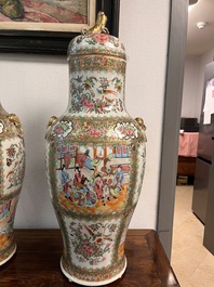 A pair of Chinese Canton famille rose vases and covers with narrative design, 19th C.
