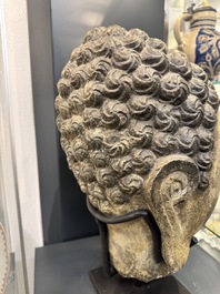 A large Chinese stone head of Buddha with traces of gilding and polychromy, Ming