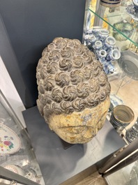 A large Chinese stone head of Buddha with traces of gilding and polychromy, Ming