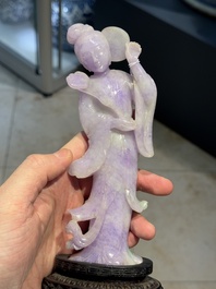 A Chinese lavender- and mint-green-jade figure of a goddess holding a sceptre and fan on wooden stand, 19th C.