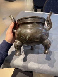 A Chinese bronze tripod censer with two handles, Ming