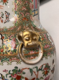 A pair of Chinese Canton famille rose vases and covers with narrative design, 19th C.