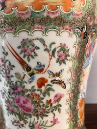 A pair of Chinese Canton famille rose vases and covers with narrative design, 19th C.