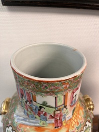 A pair of Chinese Canton famille rose vases and covers with narrative design, 19th C.