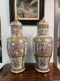 A pair of Chinese Canton famille rose vases and covers with narrative design, 19th C.