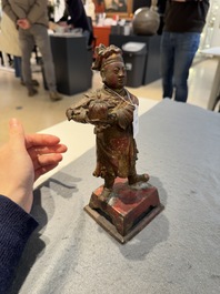 A Chinese gilt-lacquered bronze offering figure on stand, Ming