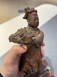 A Chinese gilt-lacquered bronze offering figure on stand, Ming