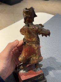A Chinese gilt-lacquered bronze offering figure on stand, Ming