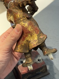 A Chinese gilt-lacquered bronze offering figure on stand, Ming