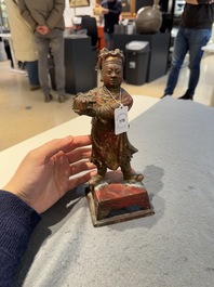 A Chinese gilt-lacquered bronze offering figure on stand, Ming