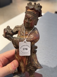 A Chinese gilt-lacquered bronze offering figure on stand, Ming