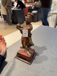 A Chinese gilt-lacquered bronze offering figure on stand, Ming
