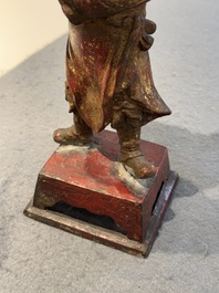 A Chinese gilt-lacquered bronze offering figure on stand, Ming