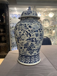 A large Chinese blue and white 'birds among blossoming branches' vase and cover, 19th C.
