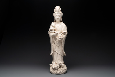 A large Chinese Dehua blanc de Chine group of a Bodhisattva with child, 20th C.