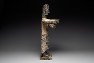 A large Chinese Sanxingdui-style marble sculpture of a standing figure, 20th C.