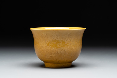 A Chinese yellow-glazed 'anhua' 'carp and lotus' bowl, Kangxi mark, 19th C.