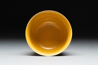 A Chinese yellow-glazed 'anhua' 'carp and lotus' bowl, Kangxi mark, 19th C.