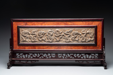 A Chinese wooden table screen with a carved stone 'dragon' plaque, 20th C.