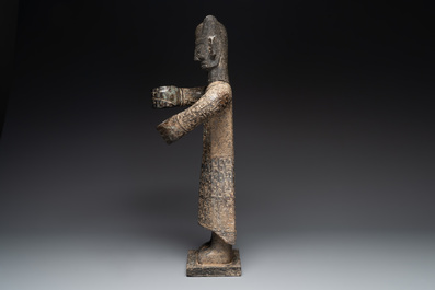 A large Chinese Sanxingdui-style marble sculpture of a standing figure, 20th C.