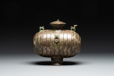 Two large Chinese archaistic bronze rhino- and melon-form vessels, 20th C.