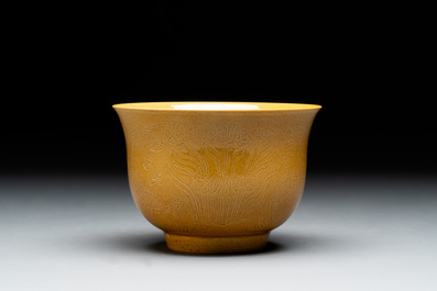 A Chinese yellow-glazed 'anhua' 'carp and lotus' bowl, Kangxi mark, 19th C.