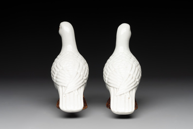 A pair of Chinese white-glazed Buddhist lions, a pair of doves and a pair of iron-red-decorated cranes, Ming and later