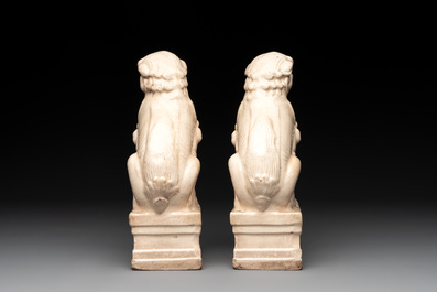 A pair of Chinese white-glazed Buddhist lions, a pair of doves and a pair of iron-red-decorated cranes, Ming and later