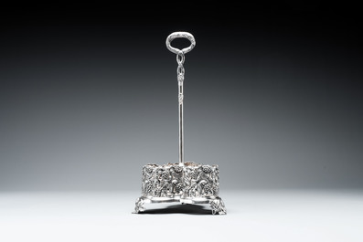 A sterling silver tantalus with three crystal-cut bottles and stoppers, 19/20th C.