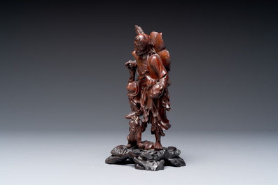 A varied collection of three Chinese brush pots, two sculptures, a lacquered covered box and a marble-inlaid wooden table screen, 20th C.