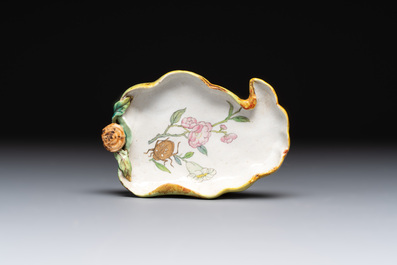 Two Chinese famille rose 'erotic' snuff bottles and a leaf-shaped saucer, 19th C.