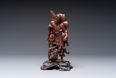 A varied collection of three Chinese brush pots, two sculptures, a lacquered covered box and a marble-inlaid wooden table screen, 20th C.