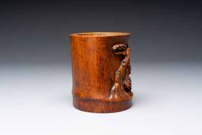 A varied collection of three Chinese brush pots, two sculptures, a lacquered covered box and a marble-inlaid wooden table screen, 20th C.