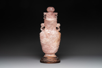 A large Chinese rose quartz vase and cover on a wooden stand, 20th C.