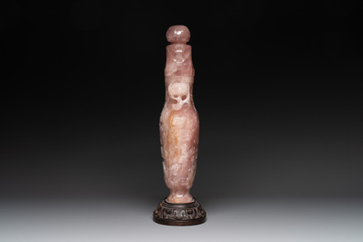 A large Chinese rose quartz vase and cover on a wooden stand, 20th C.