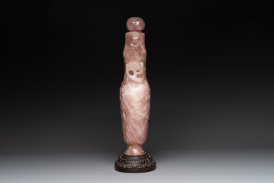 A large Chinese rose quartz vase and cover on a wooden stand, 20th C.