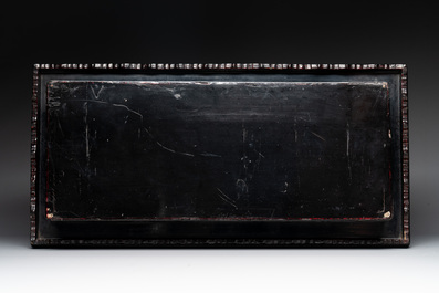 A Chinese rectangular carved red and black lacquer stand, 20th C.